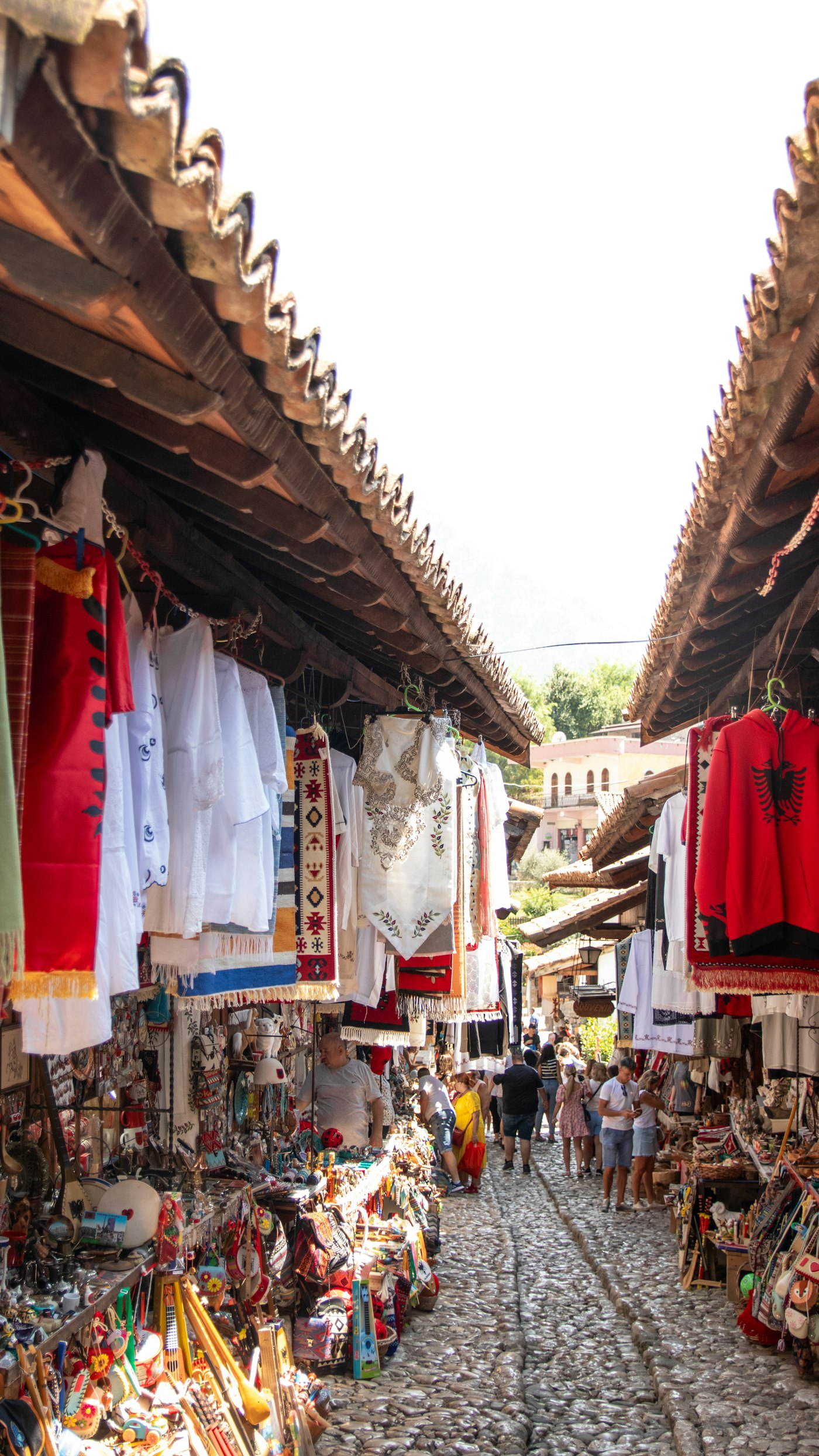 The covered cobbled Ottoman bazaar lane in Kruja, hung with textiles and souvenir stalls